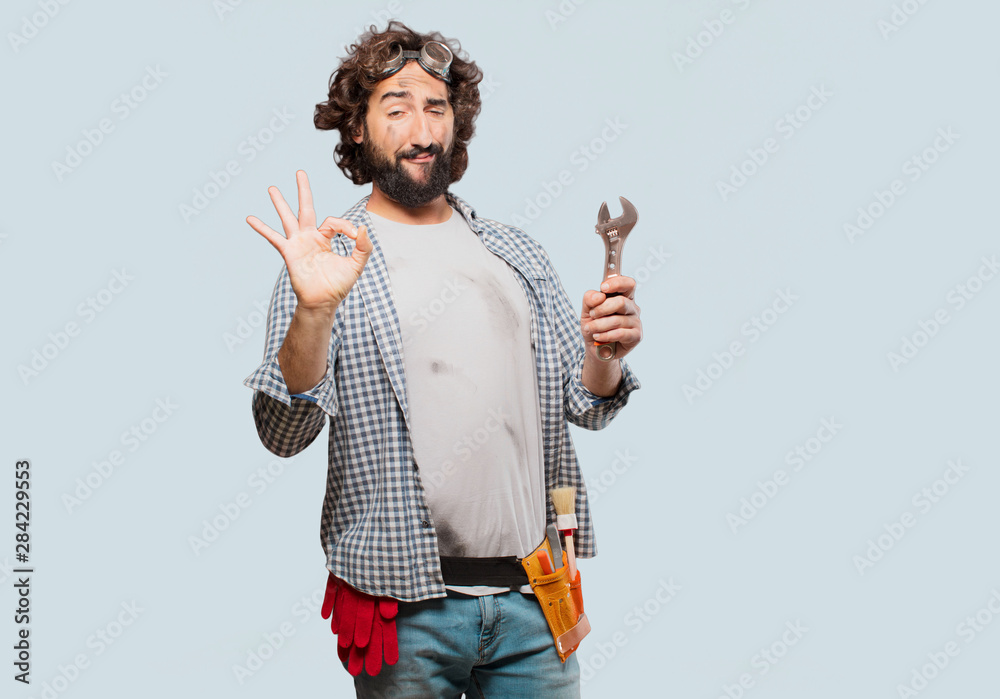 househusband handyman with a wrench - obrazy, fototapety, plakaty 