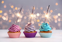 Tasty Birthday Cupcakes On Table Against Defocused Lights