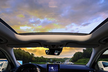 A Car Sunroof And Sunset