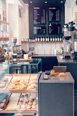 Interior design details of empty modern coffee shop restaurant at daytime. Small local business. Environment workplace of food drink server.