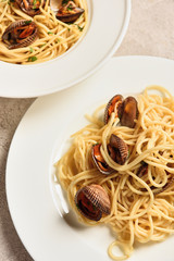 close up view of delicious pasta with seafood served in two white plates