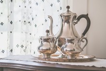 Beautiful Shot Of Silver Metal Teapots On A Metal Tray Indoors