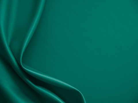 Wall Mural - Beautiful smooth elegant wavy emerald green satin silk luxury cloth fabric texture, abstract background design. Card or banner.