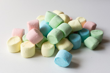 Colored marshmallows on a white background. A closeup of colored marshmallows.