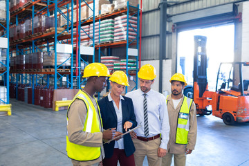 Wall Mural - Diverse staffs working together on clipboard in warehouse