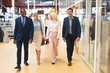 © wavebreak3 - Business people walking together in the corridor at office