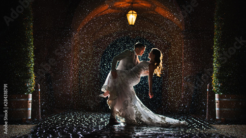 a-bride-and-groom-is-dancing-happily-in-the-rain