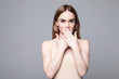 © dianagrytsku - Young pretty woman cover with hands her mouth surprised isolated on white background