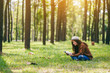 © Farknot Architect - A beautiful Asian woman reading a book while sitting in the park