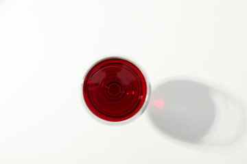 Wall Mural - Glass with red wine on white background, top view