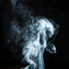 Abstract white smoke effect isolated on black background.