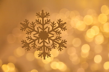 Wall Mural - Golden snowflake with glittering bokeh background with copy space for Christmas and New Year celebration and greeting card design purpose 