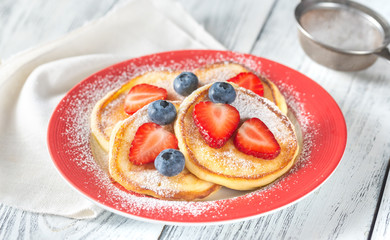 Canvas Print - Portion of ricotta fritters with fresh berries