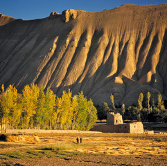 Wall Mural - Afghanistan, Bamian Valley. Sunset light creates deep shadows in the creases of the hillside in rural Bamian Valley, Afghanistan, a World Heritage Site.