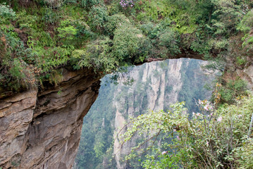 Asia, China, Hunan Province, Zhangjiajie National Forest Park. Natural stone Bridge of the Immortals connects two stone pinnacles in the Yuanjiajie Scenic Zone.