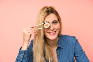 Wall Mural - Young blonde woman eating sushi