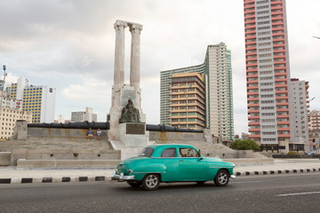 Sticker - Cuba, Havana. Vintage car passes monument.