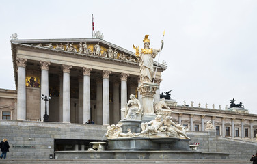 Canvas Print - austria, vienna. a romanesque statue stands on a dry water feature in front of a building with colum