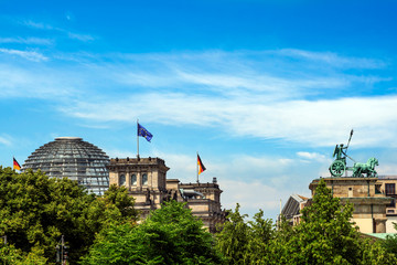 Sticker - Berlin, Germany. Side view of the Dome of the Bundestag, Reichstag, and the Quadriga atop the Brandenburg Gate (Brandenburger Tor).