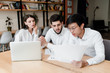 © Anastasia - colleagues in office work on laptop with papers