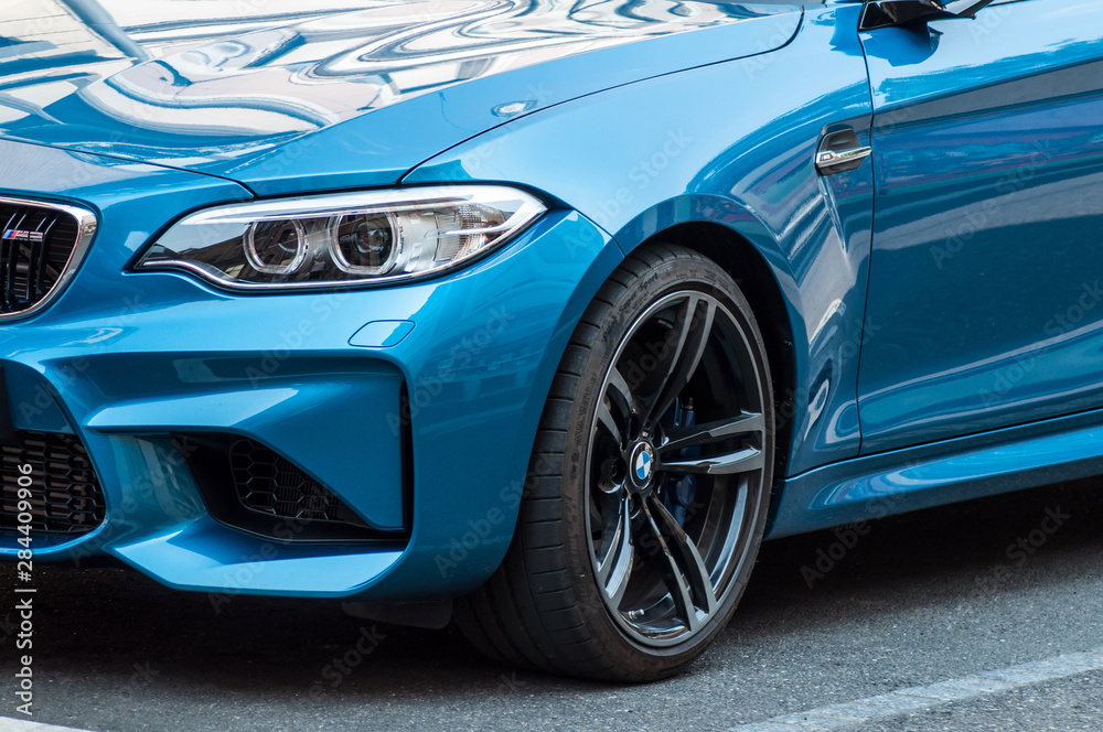  retail of blue coupe  BMW M3 parked in the street. BMW is a german brand multinational company which currently produces automotive