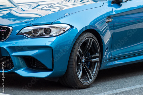 Fotografía retail of blue coupe BMW M3 parked in the street