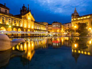 Poster - Sunset along the sidewalk of cafe and town square at dusk, Praca da Republica