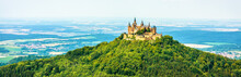 Hohenzollern Castle On Mountain Top, Germany. Panoramic View Of Burg Hohenzollern In Summer. This Castle Is Famous Landmark In Vicinity Of Stuttgart.  Landscape Of Swabian Alps With Gothic Castle.