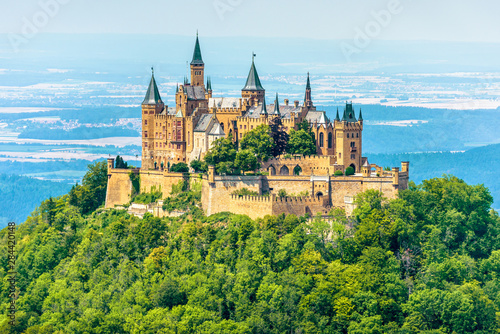 Hohenzollern Castle on mountain top, Germany. This castle is a famous landmark in vicinity of Stuttgart. Scenic view of Burg Hohenzollern in summer. Landscape of Swabian Alps with Gothic castle.