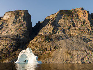 Poster - Landscape with steep yellow cliffs and icebergs in the Uummannaq fjord system, northwest Greenland.