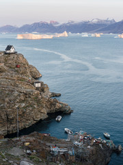 Wall Mural - Small town of Uummannaq, northwest Greenland. Background the glaciated Nuussuaq (Nuussuaq) Peninsula.