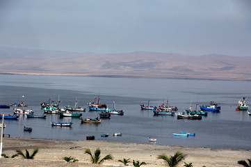 Wall Mural - Peru, San Martin. Small fishing port of San Martin with desert landscape in the distance.