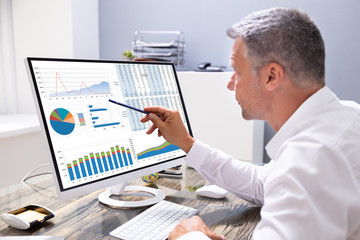 Poster - Businessman Analyzing Graphs On Computer