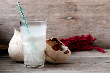 Wall Mural - Fresh coconut juice in a glass with coconut white meat isolated on white