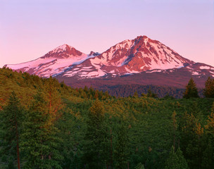 Poster - USA, Oregon, Deschutes National Forest. Sunrise reddens Middle Sister (left) and North Sister (right) in the Three Sisters Wilderness.