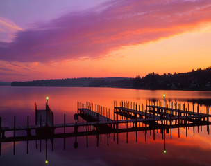 Canvas Print - USA, New Hampshire. Colors of sunrise reflecting on dock and Lake Winnipesaukee. 