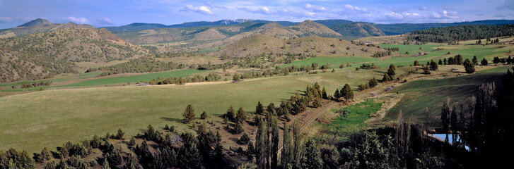 Poster - USA, Oregon, Unity. A tidy ranch fills a valley near Unity in eastern Oregon.