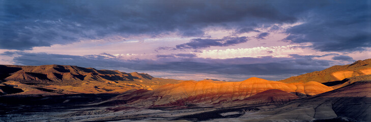 Wall Mural - USA, Oregon, John Day Fossil Beds NM. Sunset light castes long shadows at the Painted Hills section of John Day Fossil Beds NM, Oregon.