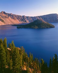 Sticker - USA, Oregon, Crater Lake National Park. Sunrise on west rim of Crater Lake with Hillman Peak (left) and Llao Rock (right) overlooking Wizard Island.