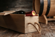 Crate With Bottle Of Wine On Wooden Table