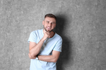 Poster - Portrait of handsome happy man on grey background. Space for text