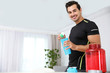 © New Africa - Young athletic man preparing protein shake at home, space for text