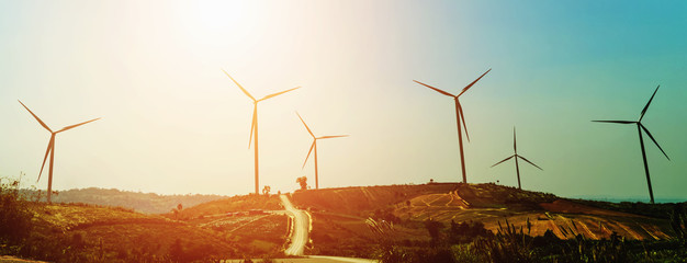 Wall Mural - concept idea eco power energy in nature. wind turbine on hill and sunset