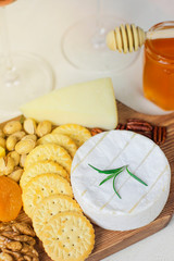 Wall Mural - cheese plate,camembert cheese ,rosemary ,crackers,dry apricot and walnuts