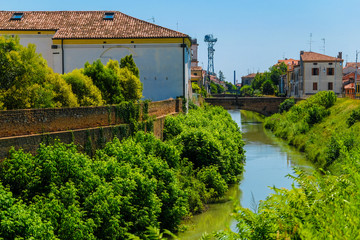 Canvas Print - Este, Italy - July, 27, 2019: Landscape with the image of channel in Este, Italy