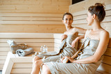 Two girlfriends relaxing in the sauna