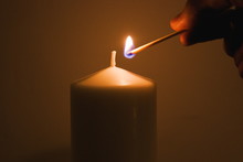 Lighting A Candle With A Burning Match