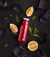 Wall Mural - Creative detox flat lay with red detox drink on black background