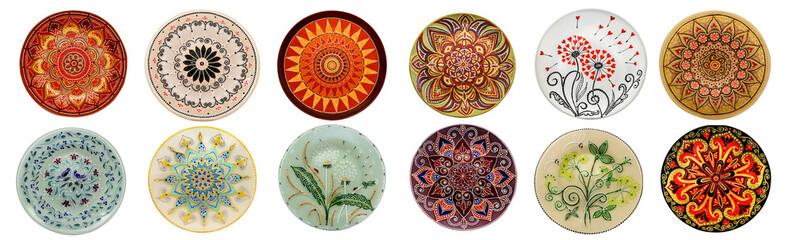 Set of decorative ceramic dishes hand-painted with acrylic paints floral pattern isolated on white background