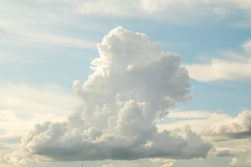 White powerfully cumulus clouds on a blue sky.